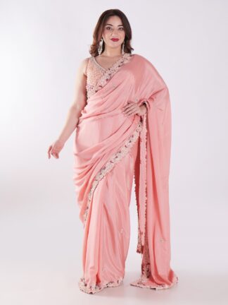 Peach Colored Party Wear Saree With Intricate Sleeveless Blouse