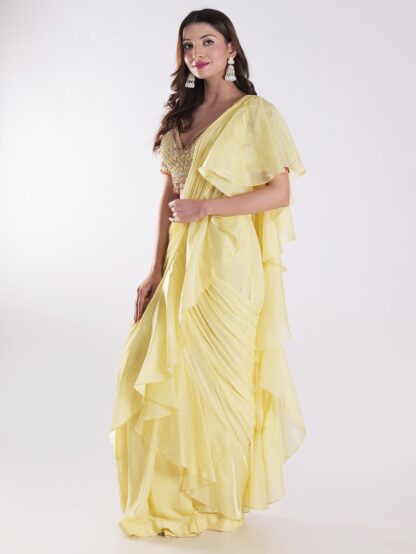 Vibrant Yellow Saree With A Ruffled Design And Golden Embellished Blouse With A Plunging Neckline