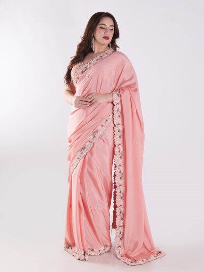 Peach Colored Party Wear Saree With Intricate Sleeveless Blouse