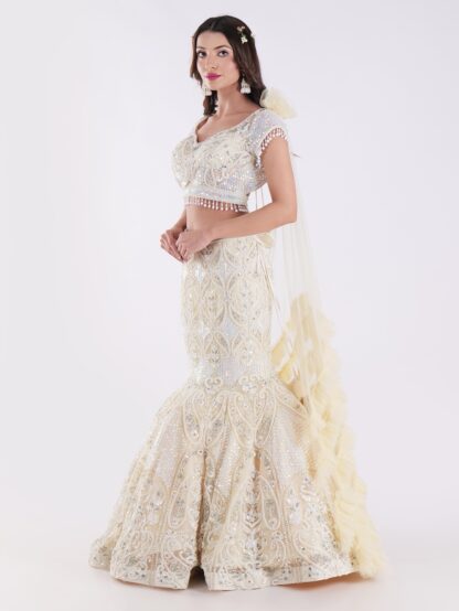 White And Cream Colored Heavily Embellished With A Sheer Dupatta Fish Cut Lehenga Set