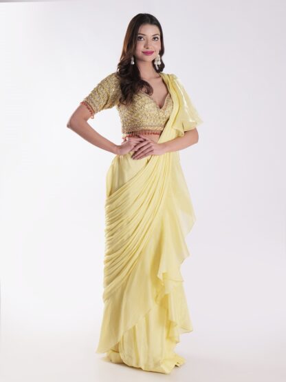 Vibrant Yellow Saree With A Ruffled Design And Golden Embellished Blouse With A Plunging Neckline