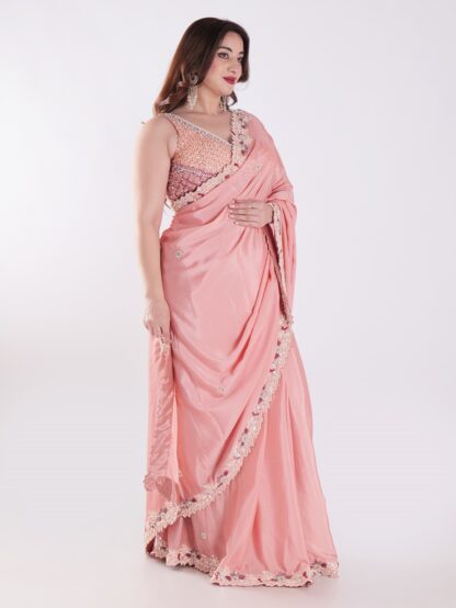 Peach Colored Party Wear Saree With Intricate Sleeveless Blouse