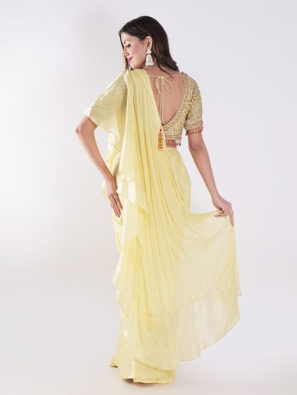 Vibrant Yellow Saree With A Ruffled Design And Golden Embellished Blouse With A Plunging Neckline