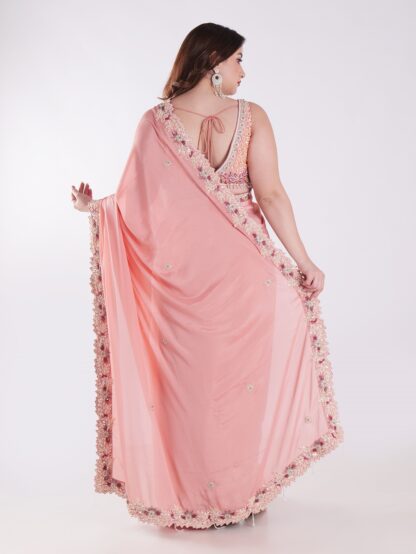 Peach Colored Party Wear Saree With Intricate Sleeveless Blouse