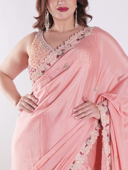 Peach Colored Party Wear Saree With Intricate Sleeveless Blouse