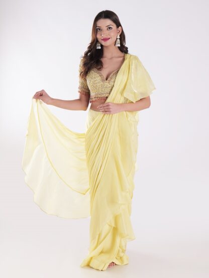 Vibrant Yellow Saree With A Ruffled Design And Golden Embellished Blouse With A Plunging Neckline