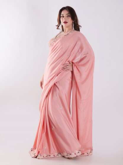 Peach Colored Party Wear Saree With Intricate Sleeveless Blouse