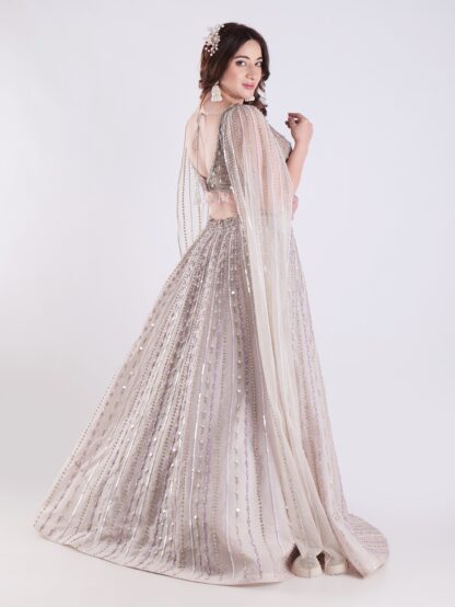 Light Colored Embrace Regal Elegance in This Champagne Sequin Embellished Lehenga Set